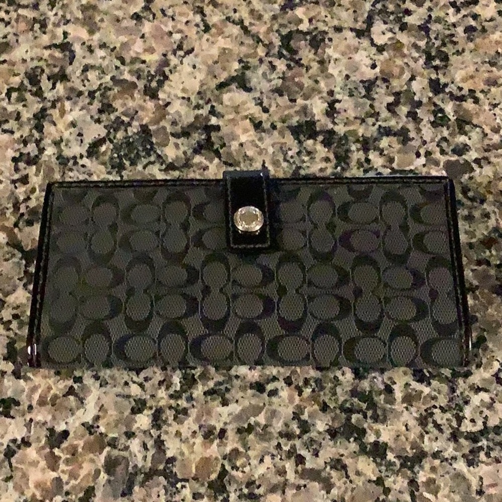 Coach sig C’s black wallet.